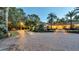 Home with a circular driveway and landscape lighting at night at 2300 N Scenic Hwy # 104, Lake Wales, FL 33898