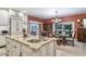Island kitchen with granite countertops, custom cabinets, and breakfast bar at 2300 N Scenic Hwy # 104, Lake Wales, FL 33898