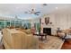 Sun-drenched living room with fireplace, hardwood floors, and ample seating at 2300 N Scenic Hwy # 104, Lake Wales, FL 33898