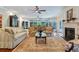 Spacious living room features a sunroom, fireplace, and hardwood floors at 2300 N Scenic Hwy # 104, Lake Wales, FL 33898
