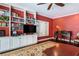 Home office with built-in shelving, desk, and hardwood floors at 2300 N Scenic Hwy # 104, Lake Wales, FL 33898