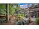 Outdoor patio with pergola, table and chairs, and lush greenery at 2300 N Scenic Hwy # 104, Lake Wales, FL 33898