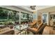Bright sunroom features wicker furniture and serene garden views at 2300 N Scenic Hwy # 104, Lake Wales, FL 33898
