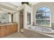 Bathroom with soaking tub, shower, and large window at 231 Terranova Blvd, Winter Haven, FL 33884