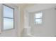 Small bathroom with tub and exterior access at 231 Terranova Blvd, Winter Haven, FL 33884