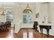 Bright entryway with hardwood floors and a view into the dining room at 231 Terranova Blvd, Winter Haven, FL 33884