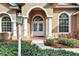 Arched entryway with double doors, white columns, and brick walkway at 231 Terranova Blvd, Winter Haven, FL 33884