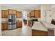 Spacious kitchen with light wood cabinets and stainless steel appliances at 231 Terranova Blvd, Winter Haven, FL 33884