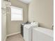 Laundry room with washer, dryer, and overhead shelving at 231 Terranova Blvd, Winter Haven, FL 33884