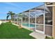 Screened-in pool with a spacious patio and lush green grass at 231 Terranova Blvd, Winter Haven, FL 33884