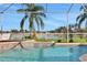 Relaxing screened-in pool with water feature, overlooking a lake at 231 Terranova Blvd, Winter Haven, FL 33884