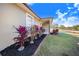 Neatly landscaped yard with red plants along house exterior at 3955 Dietz Rd, Bartow, FL 33830