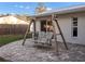 Relaxing brick patio with wooden swing, perfect for outdoor enjoyment at 4210 Old Colony Rd, Mulberry, FL 33860