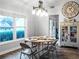 Bright dining room features a rustic table, chandelier, and large windows at 4210 Old Colony Rd, Mulberry, FL 33860