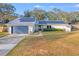 House exterior featuring a metal roof, solar panels, and a landscaped lawn at 4210 Old Colony Rd, Mulberry, FL 33860