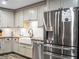 Stainless steel refrigerator and white farmhouse sink in the kitchen at 4210 Old Colony Rd, Mulberry, FL 33860