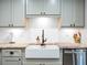 Farmhouse sink with granite countertop and shaker cabinets at 4210 Old Colony Rd, Mulberry, FL 33860