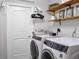 Convenient laundry room with washer, dryer, and shelving at 4210 Old Colony Rd, Mulberry, FL 33860