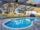 Inviting kidney-shaped pool with a screened enclosure at 4210 Old Colony Rd, Mulberry, FL 33860