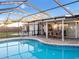 Relaxing kidney-shaped pool with a screened patio cover at 4210 Old Colony Rd, Mulberry, FL 33860