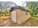 Tan block shed with white door in the backyard at 4504 Crystal Beach Rd, Winter Haven, FL 33880