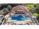 Aerial view of community pool and surrounding patio furniture at 603 Sweet Bay Cir # 603, Winter Haven, FL 33884