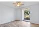Bedroom with wood-look floors and sliding glass door to patio at 603 Sweet Bay Cir # 603, Winter Haven, FL 33884