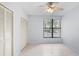 Bright bedroom with tile floors, double closets, and a large window at 603 Sweet Bay Cir # 603, Winter Haven, FL 33884