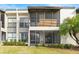 Building exterior with screened patios and landscaping at 603 Sweet Bay Cir # 603, Winter Haven, FL 33884