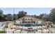 Community pool and clubhouse with surrounding patio and lounge area at 603 Sweet Bay Cir # 603, Winter Haven, FL 33884