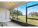 Screened patio with table and chairs overlooking lake at 603 Sweet Bay Cir # 603, Winter Haven, FL 33884