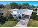 Elevated view of a manufactured home with a carport and yard at 6633 Westchester Ne Dr, Winter Haven, FL 33881