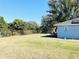 Large backyard with grassy area and chain link fence at 707 E Frederick Ave, Dundee, FL 33838