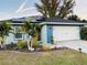 Newly built home with solar panels, landscaped yard, and two-car garage at 707 E Frederick Ave, Dundee, FL 33838