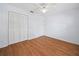 Bedroom with wood-look floors and double door closet at 723 Canberra Rd, Winter Haven, FL 33884