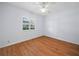 Light and airy bedroom with wood-look flooring and window shutters at 723 Canberra Rd, Winter Haven, FL 33884