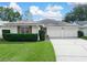 White single-story house with a two-car garage and well-manicured lawn at 723 Canberra Rd, Winter Haven, FL 33884