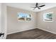 Empty bedroom with neutral walls, wood-look flooring, and two windows at 80 Garrison Ln, Frostproof, FL 33843