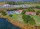Community amenities with a pool, tennis court, and nearby buildings, waterfront view in background at 802 Magnolia Pl, Winter Haven, FL 33884