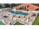 Inviting community pool with a hot tub, lounge chairs, and covered seating areas at 802 Magnolia Pl, Winter Haven, FL 33884