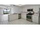 Bright kitchen with white cabinets, stainless steel appliances, and a view of the water at 802 Magnolia Pl, Winter Haven, FL 33884