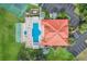 Community pool with lounge chairs, shuffleboard court, and a clubhouse at 802 Magnolia Pl, Winter Haven, FL 33884