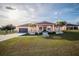 One-story home with peach siding, dark brown garage door, and landscaping at 8243 Alturas Rd, Bartow, FL 33830