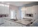 Spacious kitchen with white cabinets, granite island, and breakfast bar at 8243 Alturas Rd, Bartow, FL 33830