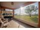 Relaxing screened porch with lake view and outdoor seating at 8243 Alturas Rd, Bartow, FL 33830