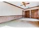 Large, empty bedroom with wall-to-wall carpeting and wood paneling at 9 Skidmore Rd, Winter Haven, FL 33884