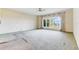 Spacious bedroom with carpeting, a bay window with lake views, and wainscoting at 9 Skidmore Rd, Winter Haven, FL 33884