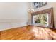 Formal dining room featuring wood floors and a large window with natural light at 9 Skidmore Rd, Winter Haven, FL 33884