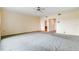 Spacious living room with carpeted floors and access to another room at 9 Skidmore Rd, Winter Haven, FL 33884