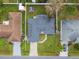 Aerial view showing house with solar panels and driveway at 910 Nancy Ct, Kissimmee, FL 34759
